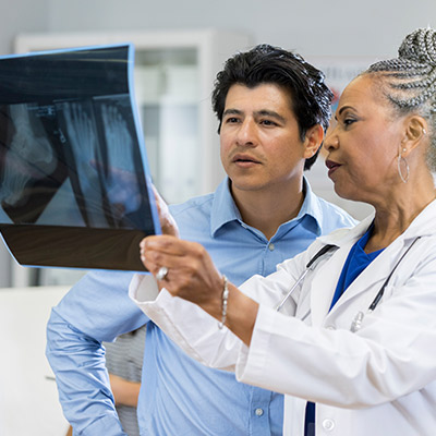 Specialist reviewing an x-ray with a patient.