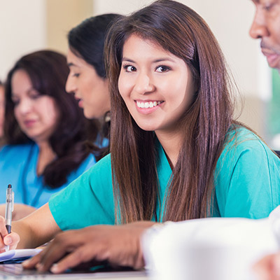 A young medical clinic staff person learning something that she will champion with her colleagues