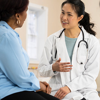 A senior woman of african descent is having a conversation with her female doctor.